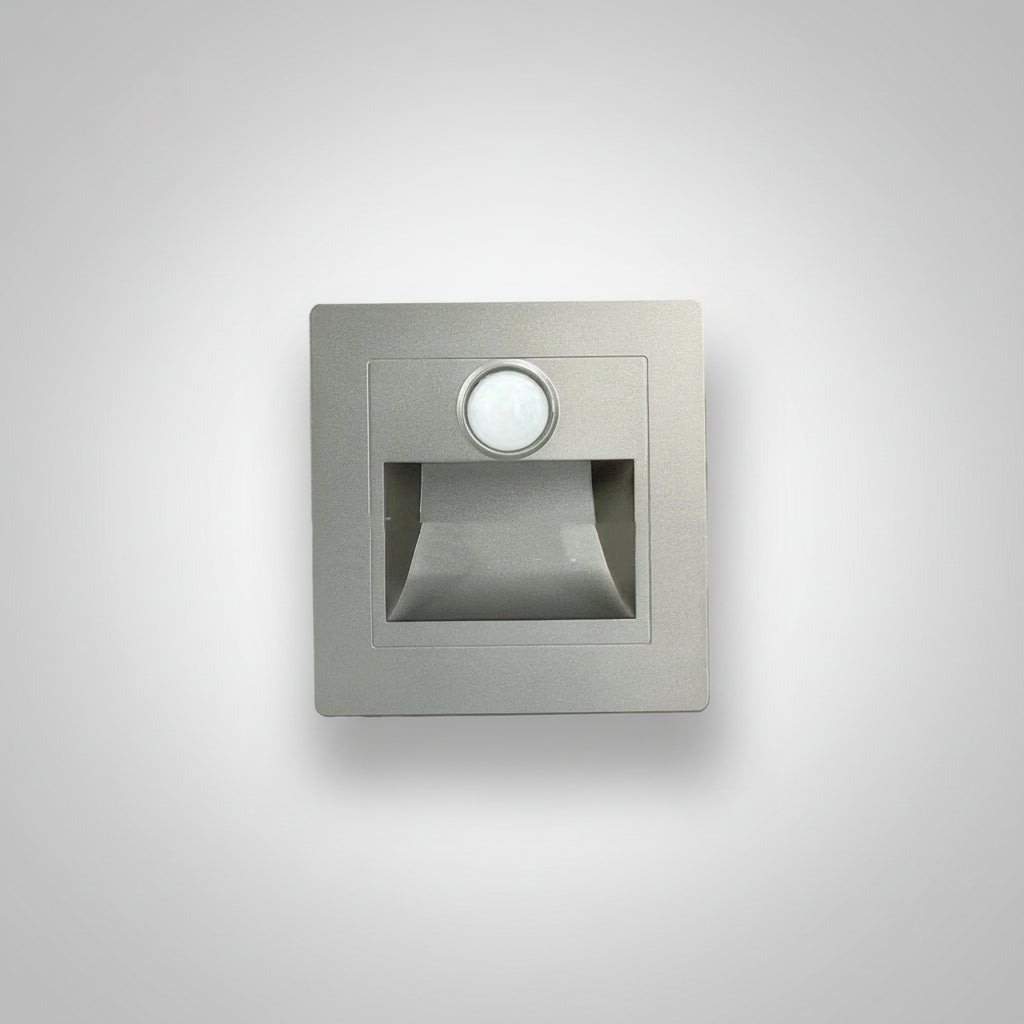 Square metallic sensor light on a white background