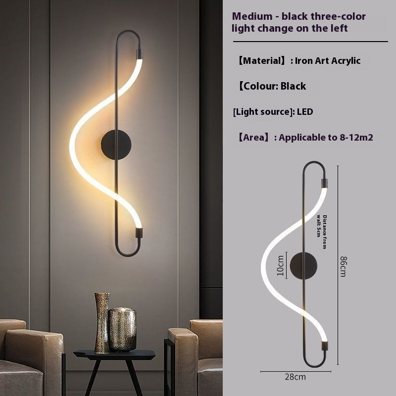 Modern wall light fixture with black three-color light change on a gray wall.