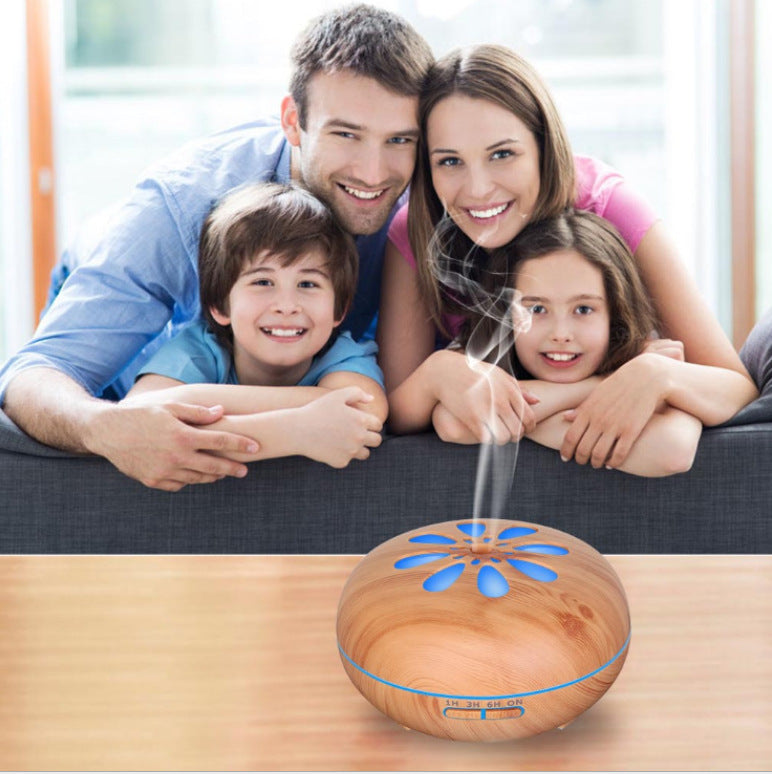 Family of four with a wooden diffuser on a table