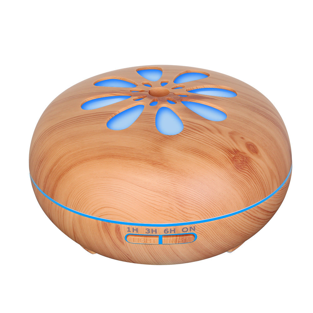 Wooden diffuser with blue LED lights on a white background