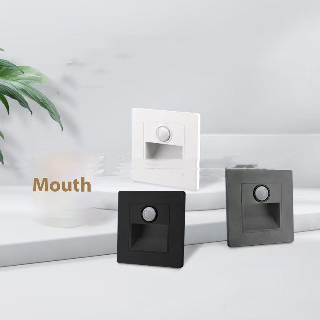 Three square light switches in black, white, and gray on a white surface with 'Mouth' text.