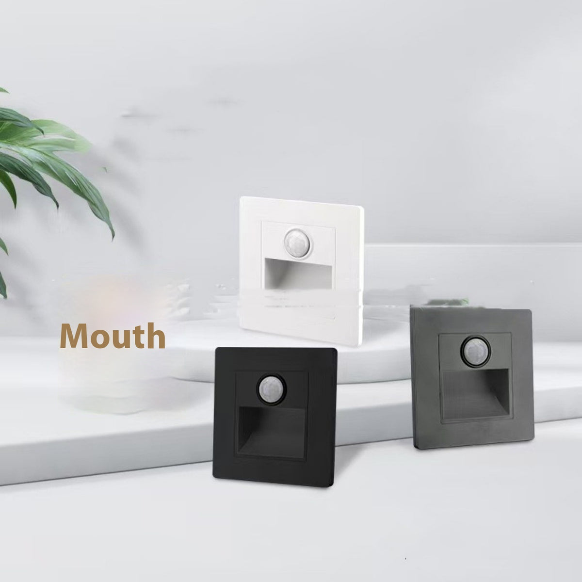 Three square light switches in black, white, and gray on a white surface with 'Mouth' text.