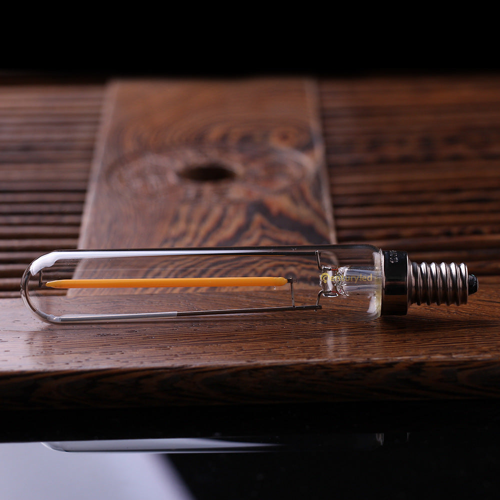 Clear LED light bulb on a wooden surface