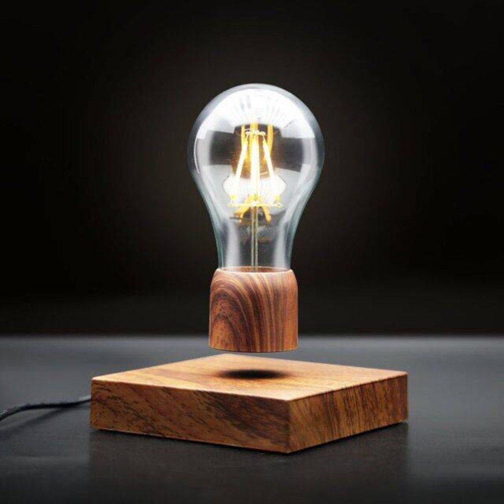 Light bulb on a wooden base against a dark background