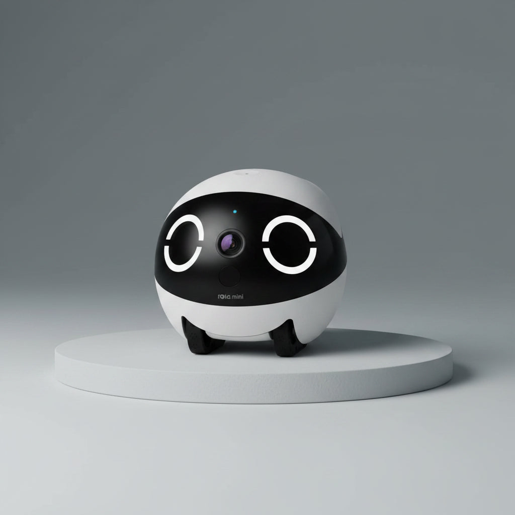 ROLA Mini pet monitor front view White and black robot toy with a camera on a white background