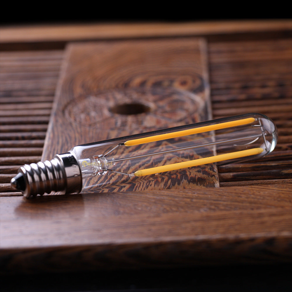 Vintage-style light bulb on a wooden surface