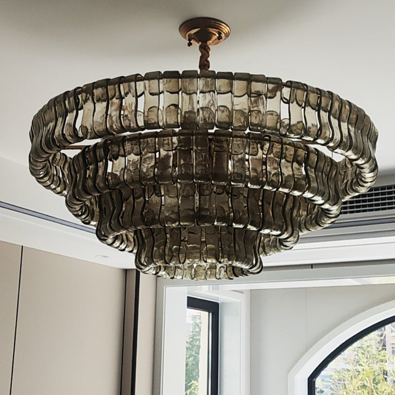 Decorative chandelier hanging in a room with windows