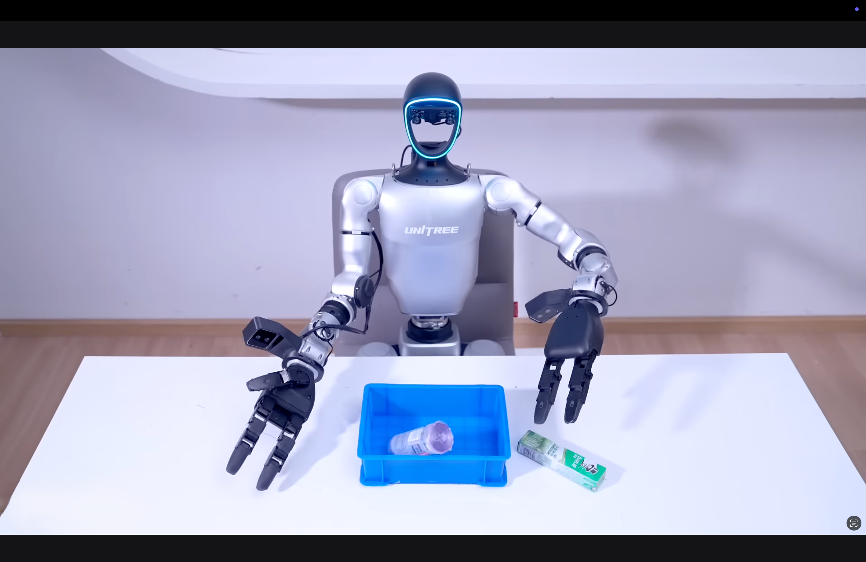 Robot with a blue tray containing a bottle and a tube on a white surface.